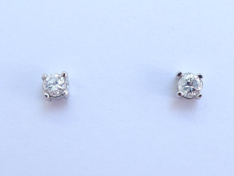 A pair of 18 carat white gold and single stone diamond ear studs, each brilliant approx. 0.12 carat,