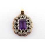 An amethyst and diamond pendant, the central emerald cut amethyst 8.8 x 7 x 4.7mm, in a surround