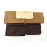 Loewe. Two Loewe makeup pouches, both in dark brown leather with the logo impressed, each in