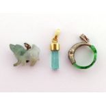 Three green stone pendants, including a rough emerald crystal, the yellow mount stamped '18ct',