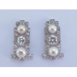 A pair of Art Deco diamond and pearl (untested) earrings, the central old and transition cut