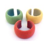 Three shagreen cuff bangles, in pastel yellow, green and pink, leather lined, 5.2cm inner