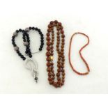 Three costume bead necklaces, including sponge coral, carved wood, and paste set examples (3)