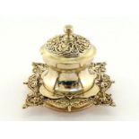 A late Victorian silver inkwell by Gibson & Langman, London, 1896, shaped square base chased with