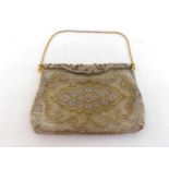 A very fine beadwork evening bag with a decorative pattern of white and yellow metal beads, sprung