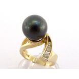 A Tahitian cultured pearl and diamond ring, the large pearl 12.3mm diameter, obliquely set, the tail