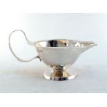 A very stylish silver sauceboat by Frank Gardiner Fedden, London, 1933, spot-hammered sides and wavy