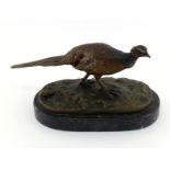 A cold painted bronze pheasant on naturalistic moorland base, signed in the cast “I Menie”, on