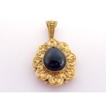 An early Victorian gold and carbuncle (almandine garnet) pendant, the central pear shaped cabochon