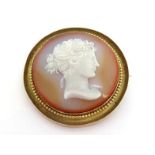 A elegant 19th century agate cameo, circa 1860, the circular cameo depicting a classical female in