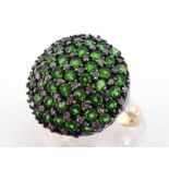 A diamond and green stone bombe dress ring, the large circular bezel pave set with a chequer board