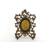An oval gilt bronze bust of William Shakespeare in profile within a malachite mount in an oval