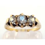A late Victorian diamond three stone ring, claw set with three graduated mine cut stones, the