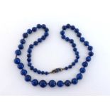 A lapis lazuli bead necklace, composed of graduated 12.3-5.5mm beads, to a gold and seed pearl set