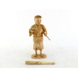A Japanese bone carving figure and a cigarette holder, 20th century, 16.5cm high and 10cm long,