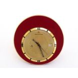 Jaeger LeCoultre, Memovox, a gilt metal and enamel travel clock, no. 1107812, the slim circular
