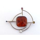 An Italian silver and synthetic amber brooch, gem set to the cardinal points, 8cm wide, 26.7gms
