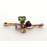 A late 19th century gem set clover brooch, the central clover claw set with a peridot, amethyst,