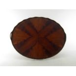 A galleried two handled oval drinks tray in matched quartered yew veneer. 54x44cm.