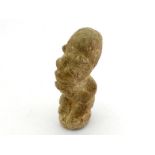A carved African limestone figure, possibly ancient. Ht. 11cm.
