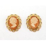 A pair of modern shell cameo ear studs, the small oval cameos 10mm long, with scroll work frame (