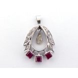 A 9 carat gold, ruby and diamond pendant, the small spectacle set marquise cut suspended to the