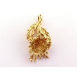 A yellow metal (tests 14 carat gold) flower pendant, 3cm long, 4gms