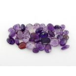 A mixed lot of loose oval, heart, round and cabochon cut amethysts. totalling approx. 36.82