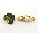 Two enamel four leaf clover brooches, the first set to the centre with an old brilliant cut diamond,