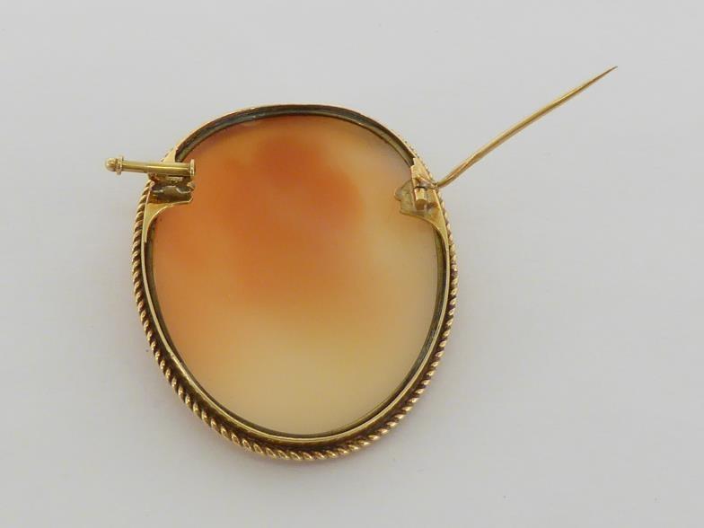 A shell cameo brooch, the large oval cameo depicting Erato, 48mm long, in a gold rope twist - Image 4 of 4
