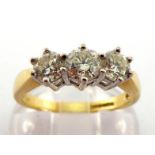 An 18 carat gold and diamond three stone ring, the three brilliant cut stones totalling approx. 0.83