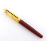 Cartier, Pasha de Cartier, a burgundy resin and gold plated fountain pen, no. 1988 4588, with fine