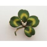 A diamond and enamel four leaf clover brooch, set to the centre with an old cut brilliant, 2cm wide,