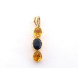 A yellow and blue sapphire pendant, composed of a line of two yellow oval cuts with a blue