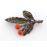 A marcasite and coral spray brooch, the two coral 'berries' 6.4mm diameter, stamped '925' verso, 5cm