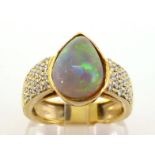 An opal and diamond ring, the pear shaped cabochon opal 12 x 9mm, to pave set brilliant cut panel