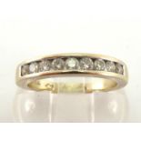A diamond half hoop ring, the nine channel set brilliants totalling approx. 0.35 carat, the inner