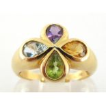 A French 18 carat and multi gem ring, the quatrefoil bezel rub over set with a pear cut amethyst,