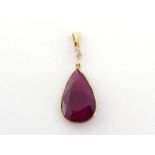 A ruby and diamond pendant, the large pear shaped ruby 22 x 14 x 5.3mm, to a small marquise cut