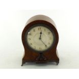 A balloon cased French walnut mantel clock on gilt brass feet and base gallery trim, engine turned