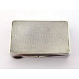 A German silver snuff box, .835 standard, with engine turned finish. CR very slight bruising to lid,