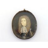 A portrait miniature of a gentleman with voluminous brown wig and lace neckerchief over armour,