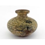 An Oriental pottery vase with dust and gilt dot finishing surface. Vase in compressed form