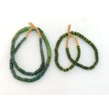 Two glass bead necklaces, composed of cylindrical shaped patterned green beads, raffia strung, 45