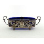 A German silver sweet dish, circa 1900, rectangular with rounded ends, angular handles hung with