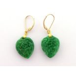 A pair of carved jade earrings, the spinach jade spade shaped pendants 20mm long, the gold hook