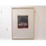Marcelle Hanselaar. A framed limited edition , 1/25, print of a red chaise longue with a box of