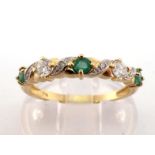 An emerald and diamond half hoop ring, composed of alternating round cut emeralds and brilliants, to