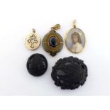 A mixed lot of late 19th century jewellery, including two bog oak brooches, a painted photograph