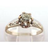 An 18 carat white gold round brilliant cut diamond ring, with diamond set shoulders, 1.7 gms